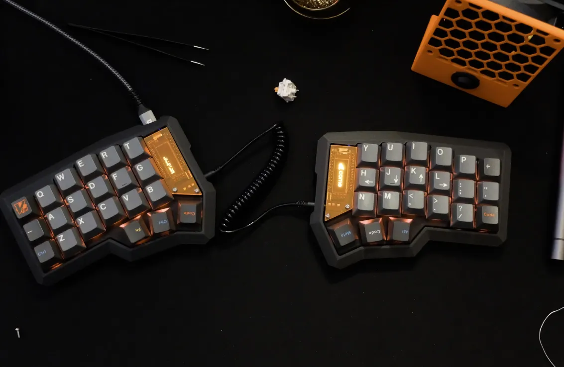 a photo of my corne keyboard with a black case, orange display covers, and GMK oblivion keycaps